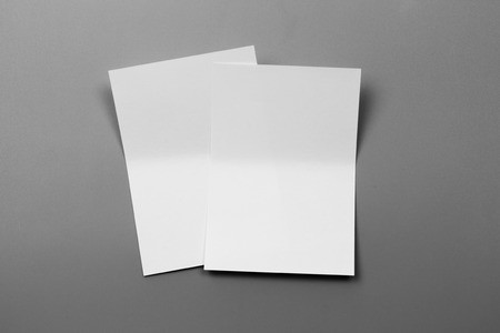 Blank portrait mock-up paper. brochure magazine isolated on gray, changeable background / white paper isolated on grayの写真素材