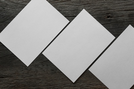 Blank portrait mock-up paper. brochure magazine isolated on brown wooden table, changeable background / white paper isolated on woodの写真素材