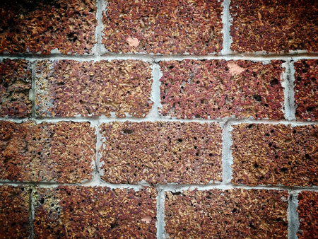 Red brick wall background with dark border