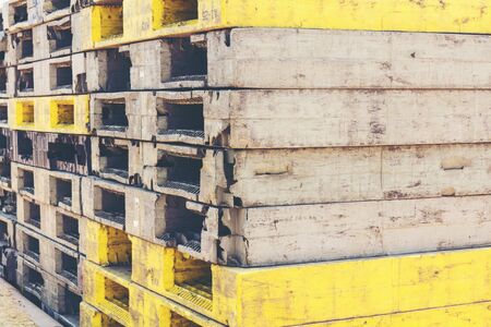 Black and yellow pallets are arranged for use.の写真素材