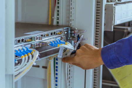 Male engineers are checking communication cable for working normally.