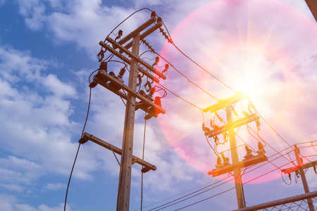 High voltage pole and sunshine. send power from clean solar energy to the community.
