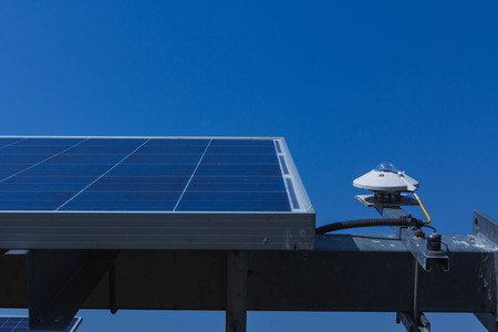 pyranometer for measuring irradiance in solar farm with blue sky.