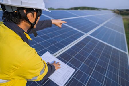 Engineering is checking the accuracy of the solar panel system installation, alternative electricity source, concept of sustainable resources.の写真素材