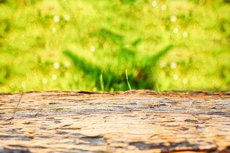 Wooden table for display products with warm sunlight and bokeh.の写真素材