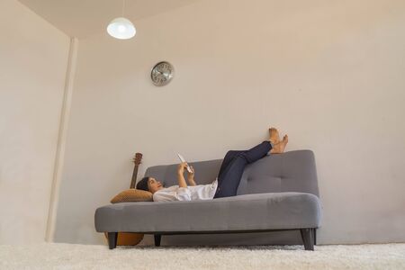 Women sleep on the bed for using the phone to shopping online.の写真素材