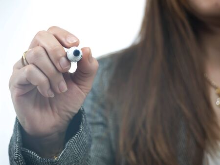 Women carrying chemical pens are going to write on the glass.の写真素材