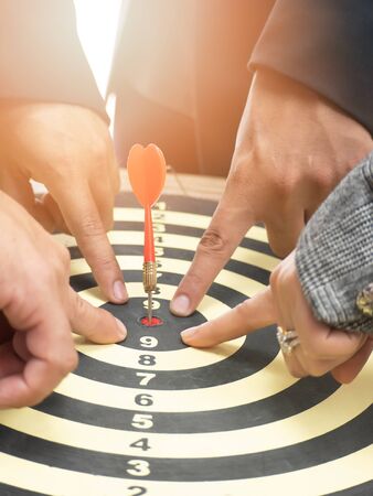 Businessman group point to a darts aiming at the target center, Target marketing and business...
