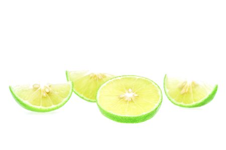 The slice of green lemons of Thailand are very sour but also very useful, placed on a white background, Isolated.の写真素材