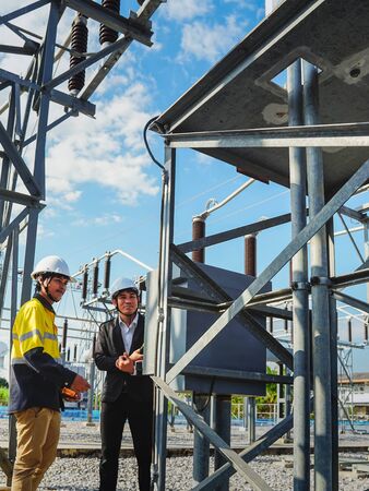 Businessmen and engineers are talking about problems and electricity production in large power...