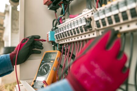 Engineering used a multimeter to measure the voltage of electrical wires produced from solar energy to confirming systems working normally and check for damage to other devices.の写真素材