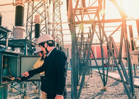 Businessmen and engineers are talking about problems and electricity production in large power...