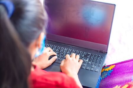 Office woman worker's wearing a medical mask and work on laptop because the company announcement to...