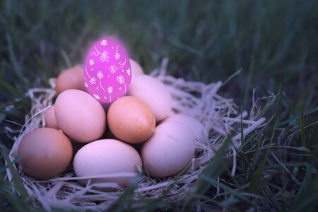 There are many eggs that are stacked together and have pink eggs is decorated with colorful colors...
