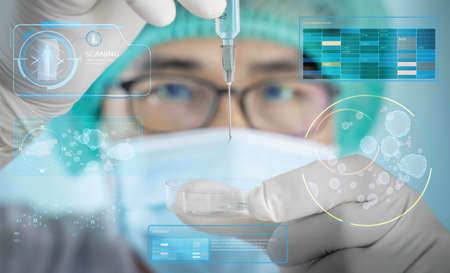 A man in a scientist's uniform was injecting a germicidal tray. The idea of inventing a vaccine to...