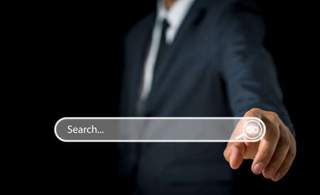 Businessman hand pressing blank search bar on a virtual online computer or screen to Searching for information. Data Search Technology Search Engine Optimization. Search Console for your website.の写真素材