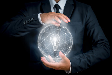 Light bulb with the lines are connected in a circle on the outside. the hands of the businessman. The concept of the business idea.の写真素材