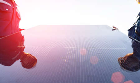 Technician is lifting the solar cell to replace the damaged one, Alternative energy to conserve the world's energy, Photovoltaic module idea for clean energy production.の写真素材