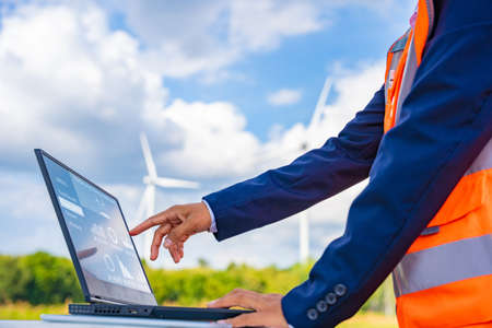 Investors on a tour of wind power plants. Wind turbines are an alternative electricity source to be sustainable resources in the future. Clean energy concept saves the world.の写真素材