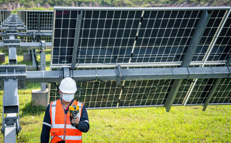 The technician takes the Thermoscan(thermal image camera) scan to the solar panel to check the hot...