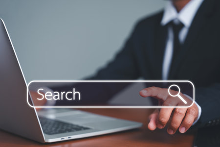 Businessman's hands are using a computer and touch the rummaging box for information. Using the search console with your website. Data routing technology search engine optimization.の写真素材