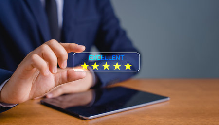 Business people are holding the virtual screen on the star icon to show satisfaction with service. Customer service and Satisfaction concept. rating very impressed.の写真素材