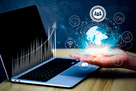 Businessman with global connection concept.Businessman Hand holding  touching global network and data exchanges over the world. Business global internet connection technology and digital marketing.の写真素材