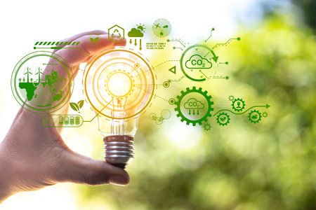 green energy concept help reduce global warming.Hand holding natural background light bulb on green...