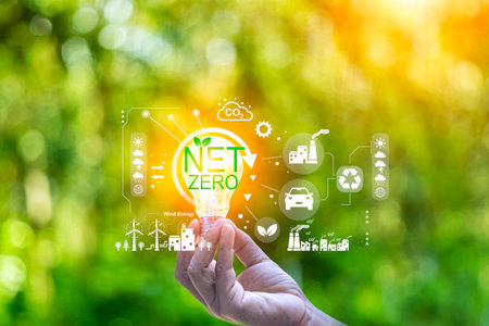 net zero concept. Hand holding with net zero icon on blur green leaf. carbon neutral and green...