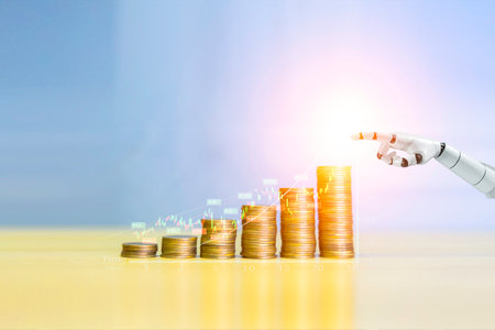 Robot trading concept. Robot hand represents use of artificial intelligence in trading stocks. Coin are laid out in graph. Wealth stock investing concept.の写真素材