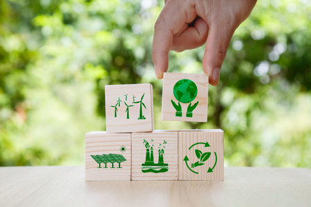 green energy icon in wood on green background. Net zero in 2050 year, ESG ecology system concept  for environmental, social, sustainable and ethical. Innovation technology helps reduce global warmingの写真素材