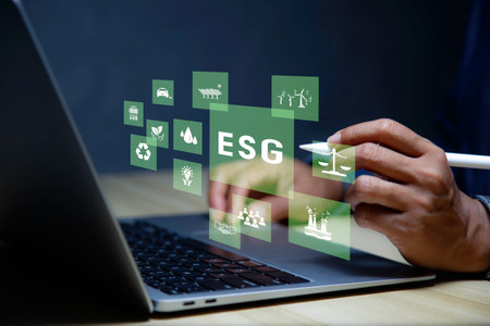 Net zero concept. Hand holding bulb with ESG icon. It is surrounded by a clean energy icon. Net zero 2050. Carbon gas affects global warming. Concept with innovation inspiration from big dataの写真素材