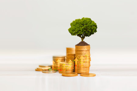 invest concept. Green tree growing on gold coins. Growing power of compound interest. Prosperous stock investment. Savings. Financial graph showing inflation. stock market chart growth investment.の写真素材