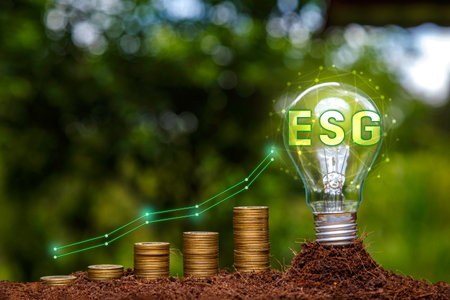 ESG icon in light bulb and Gold Coin graph on green nature background. Investing in the environment, society, governance or Investing ESG in the industrial. esg invest, green energy renewable conceptの写真素材