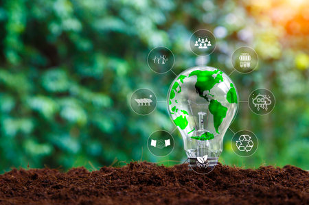 Renewable sustainable green energy icon around light bulb on green grass background. Green energy Renewable that is important to the world. Environmental protection, renewable, sustainable.の写真素材