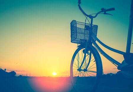 Vintage bike trails in summer tones style.classic vintage style bicycle old greeting cards, post card.close basketの写真素材