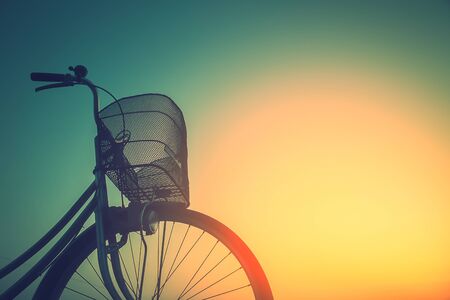 Vintage bike trails in summer tones style.classic vintage style bicycle old greeting cards, post card.close basketの写真素材