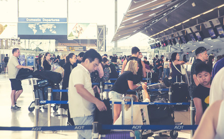 (BKK) Bangkok Airport  Suvarnabhumi - october 28 207 : people carries luggage at the airport terminal.City commuters. High key blurred image of tourist going abroad after work in holiday. Unrecognizable faces, bleached effect.のeditorial素材
