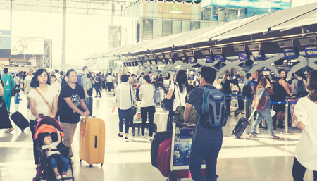 (BKK) Bangkok Airport  Suvarnabhumi - october 28 207 : people carries luggage at the airport terminal.City commuters. High key blurred image of tourist going abroad after work in holiday. Unrecognizable faces, bleached effect.のeditorial素材