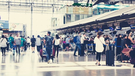 (BKK) Bangkok Airport  Suvarnabhumi - october 28 207 : people carries luggage at the airport terminal.City commuters. High key blurred image of tourist going abroad after work in holiday. Unrecognizable faces, bleached effect.のeditorial素材