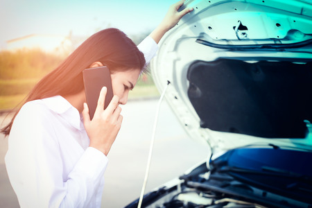 Beautiful Business woman upset because of car crash.の写真素材