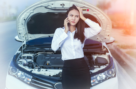 Beautiful Business woman upset because of car crash.の写真素材