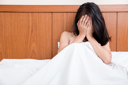woman crying in bed. Loneliness after a breakup with a man, a divorce with her husband. emotional coldnessの写真素材