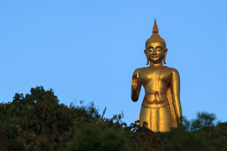 Gold Buddha Statue on blue sky backgroundの写真素材