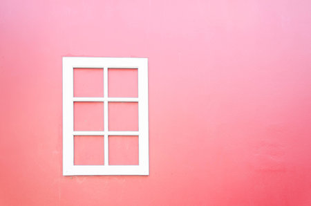 white window on pink wallの写真素材