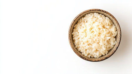 Top view of a small bowl filled with sushi rice, isolated on white with plenty of room for copyの素材