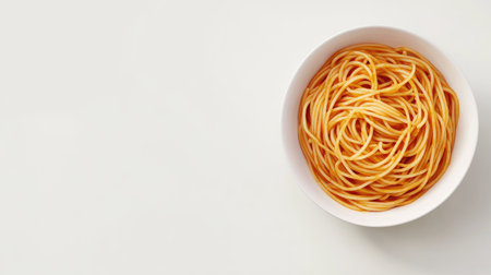 Top view of a bowl of spaghetti on a clean white background, perfect for food branding with ample copy spaceの素材
