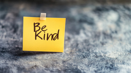 A sticky note with "Be Kind" written on it, set against a simple background, leaving space for World Kindness Day messagesの素材