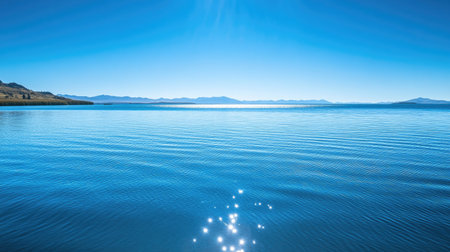 The serene blue waters of Lake Titicaca with a clear sky for text or designの素材