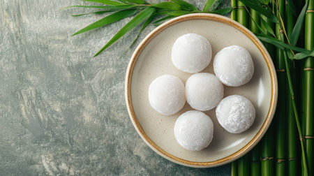 Japanese daifuku mochi on a plate with a background of bamboo, perfect for International Dessert Day.の素材